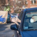 Handing Groceries to a person in an car