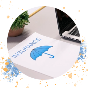 A paper on a desk that has a blue umbrella with the word 'Insurance'.