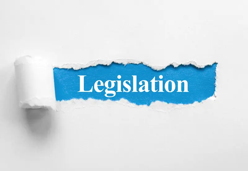 A white background that appears to be paper with a tear in it revealing the words 'legislation'
