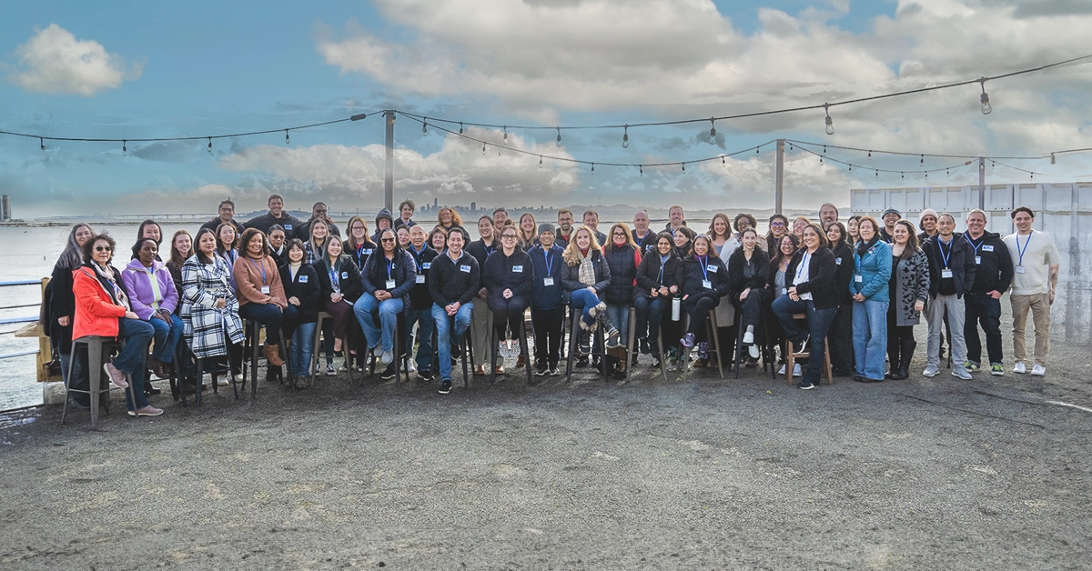 A wide photo of the entirety of the United Way Bay Area Staff against the bay with San Francisco in the distance.