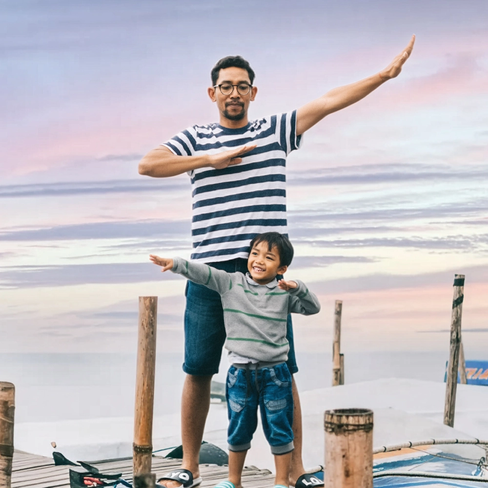 A mother holding their child into the air.