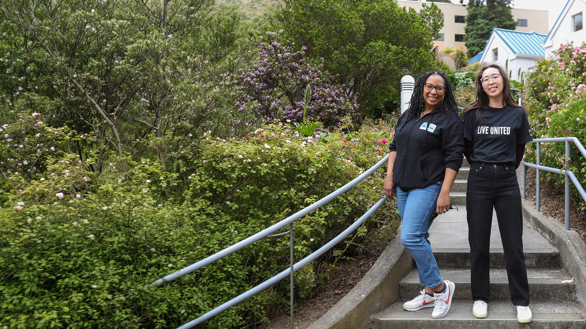 Two individuals in black shirts, one with a UWBA logo, another with the word 'volunteer'